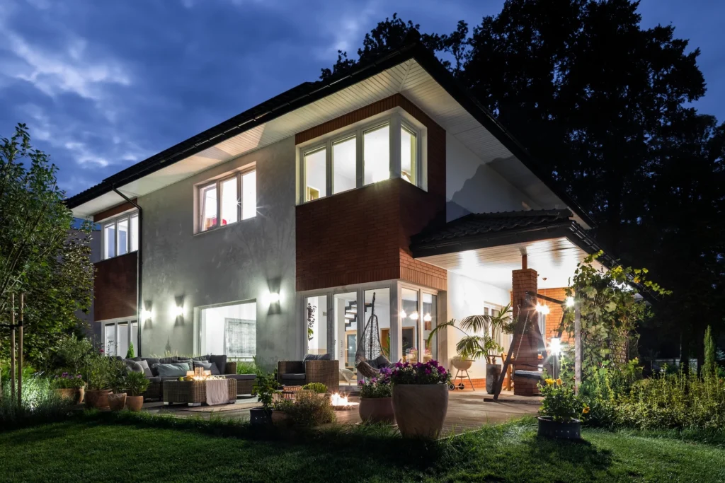big modern house with porch illuminated in the aut 2025 10 03 06 17 31 utc