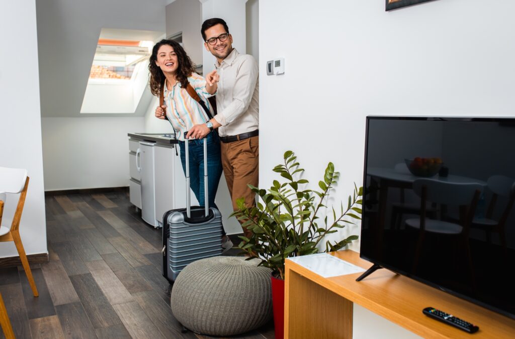 smiling couple with suitcase arriving in hotel roo 2025 01 29 08 19 41 utc
